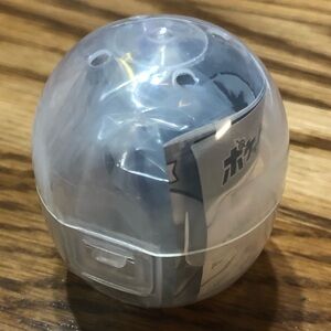 Clear Gachapon / Gashapon capsule containing a Pokémon Greavard Keychain